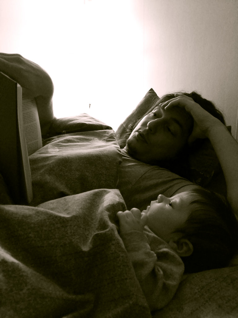 Sanjin reading to baby Florens. Photo: Lisa Sinclair.