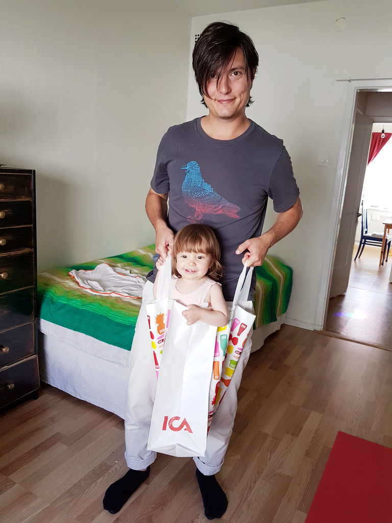 Sanjin with baby Florens in a bag. Photo: Lisa Sinclair.