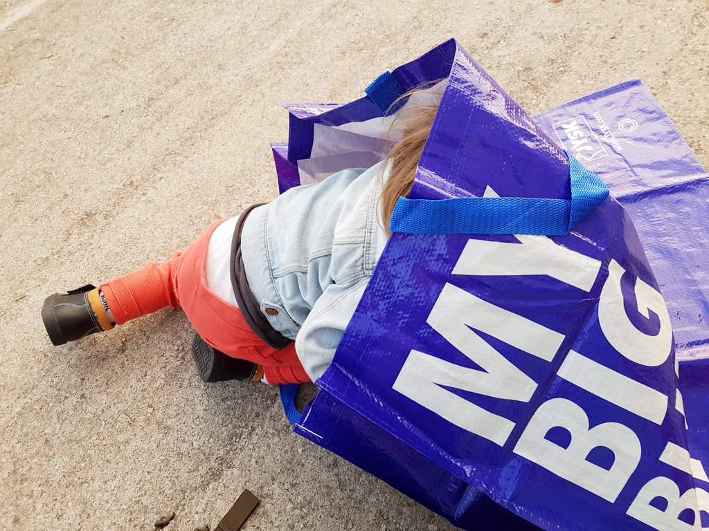 Baby Florens crawling into a big blue bag. Photo: Sanjin Đumišić.