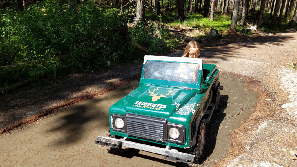 A green battery Jeep for children.