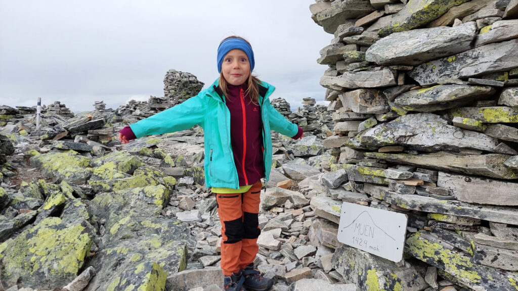 A child happy after a summit hike in Norway.